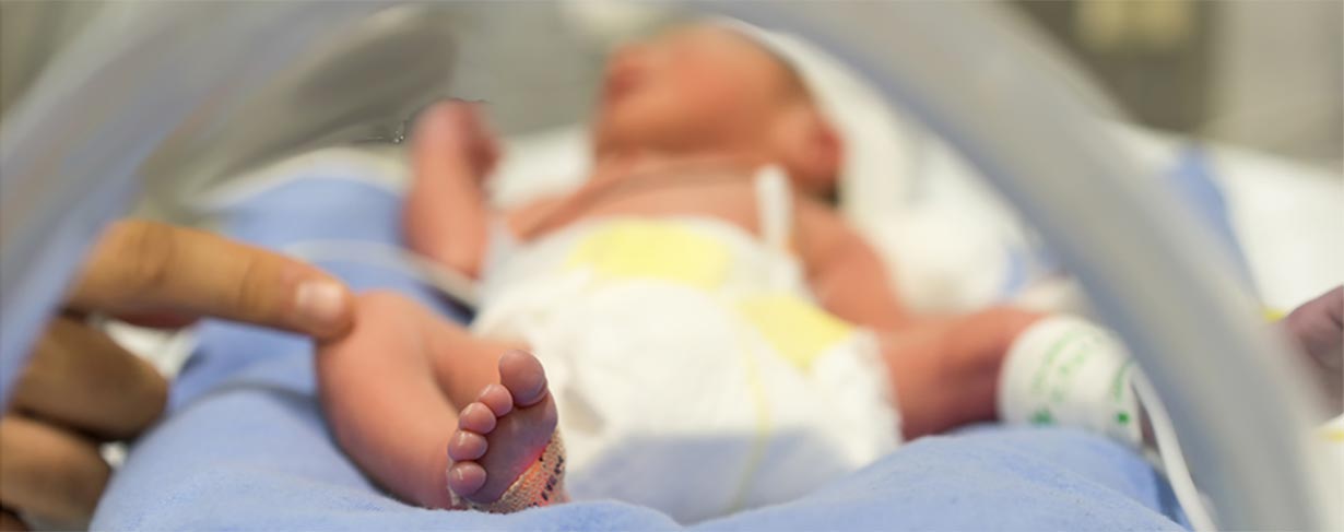 Large graphic of infant in an incubator